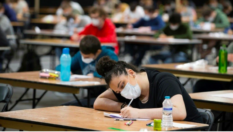 Students wearing face masks take part in an exam