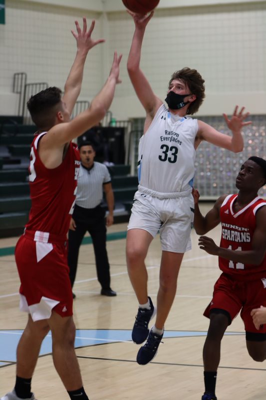 Asher Zhuk 23 drives to the basket.
