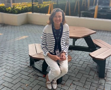 Mrs. Scarfone sitting outside the RE Bookstore. 