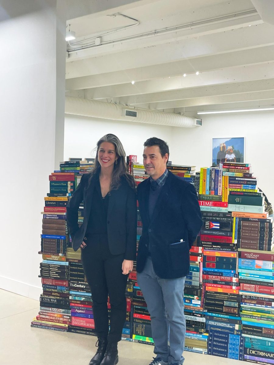 Millares and Wright in front of their wall of books; just moments before two high school students came crashing through it