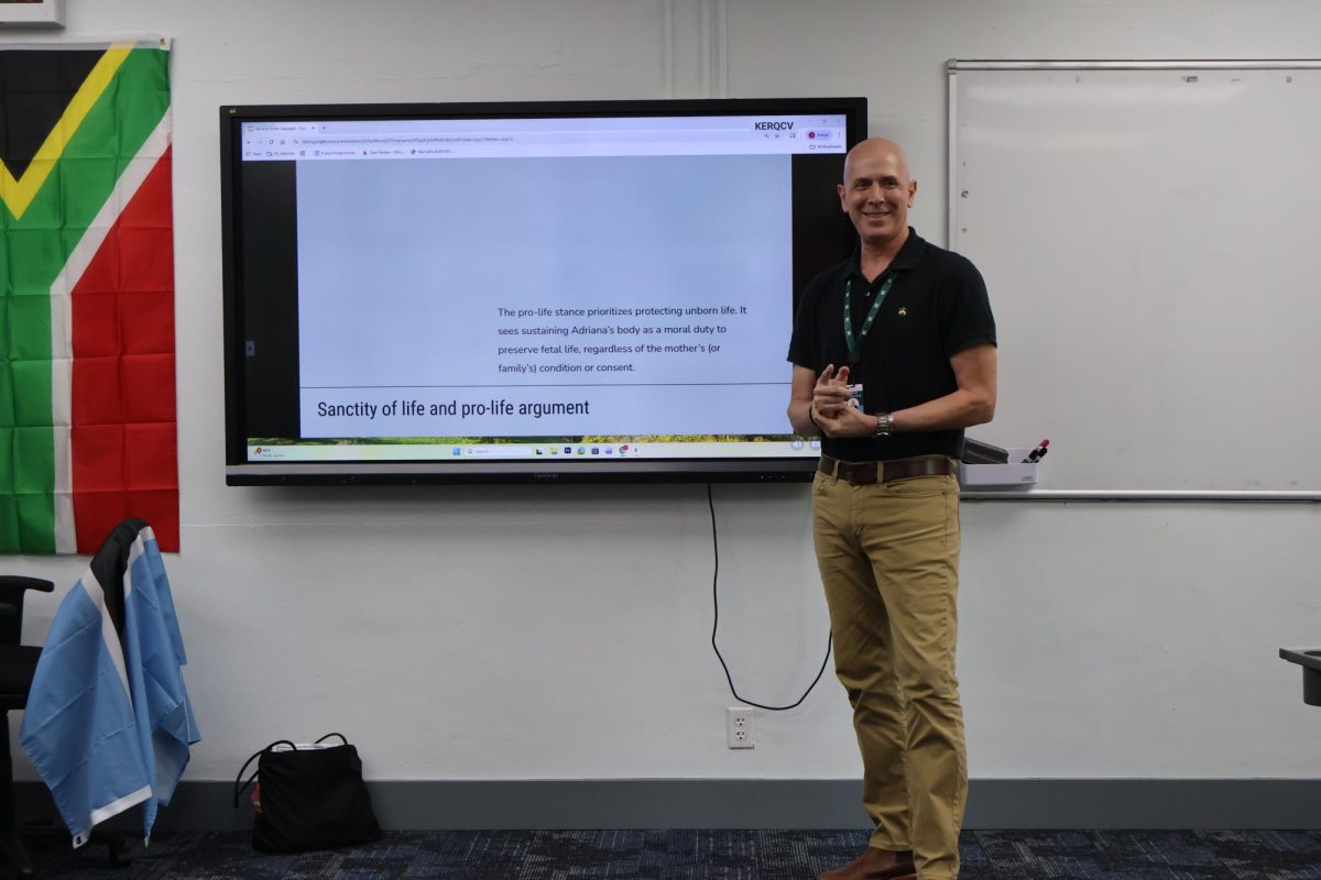 Mr Hunt teaching applied ethics in his flag-filled history classroom