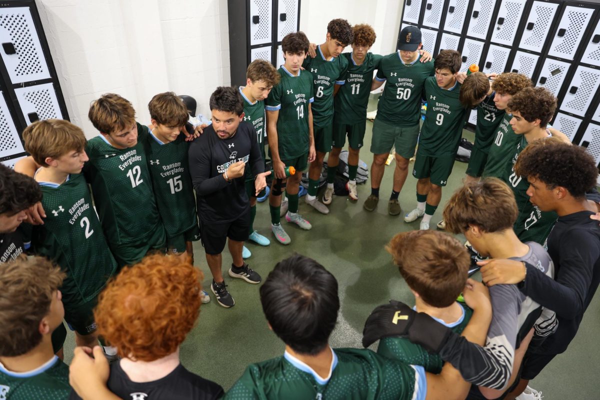 New Head Coach Teo D'Elia leads a huddle before a November game against Bridgeprep Academy