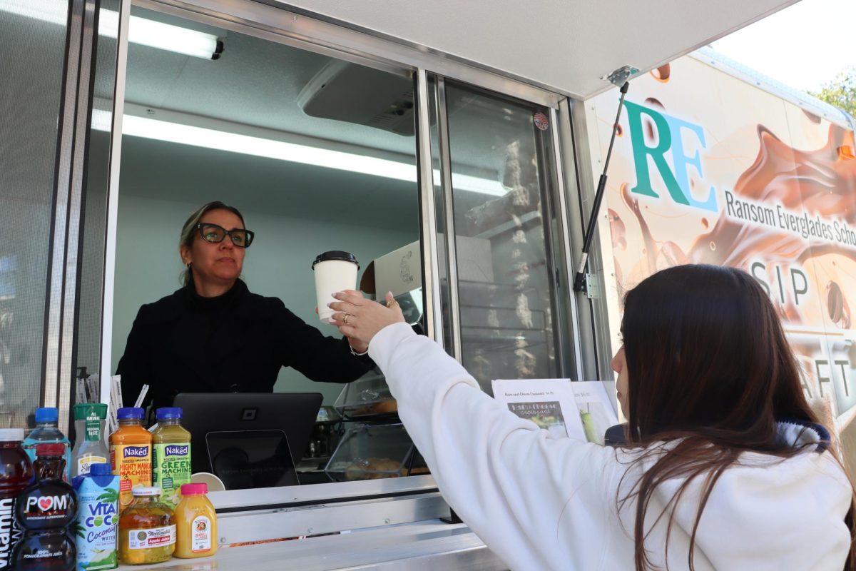 Milay Marquez serves coffee to Carlota Sarcos '28 at the new coffee truck